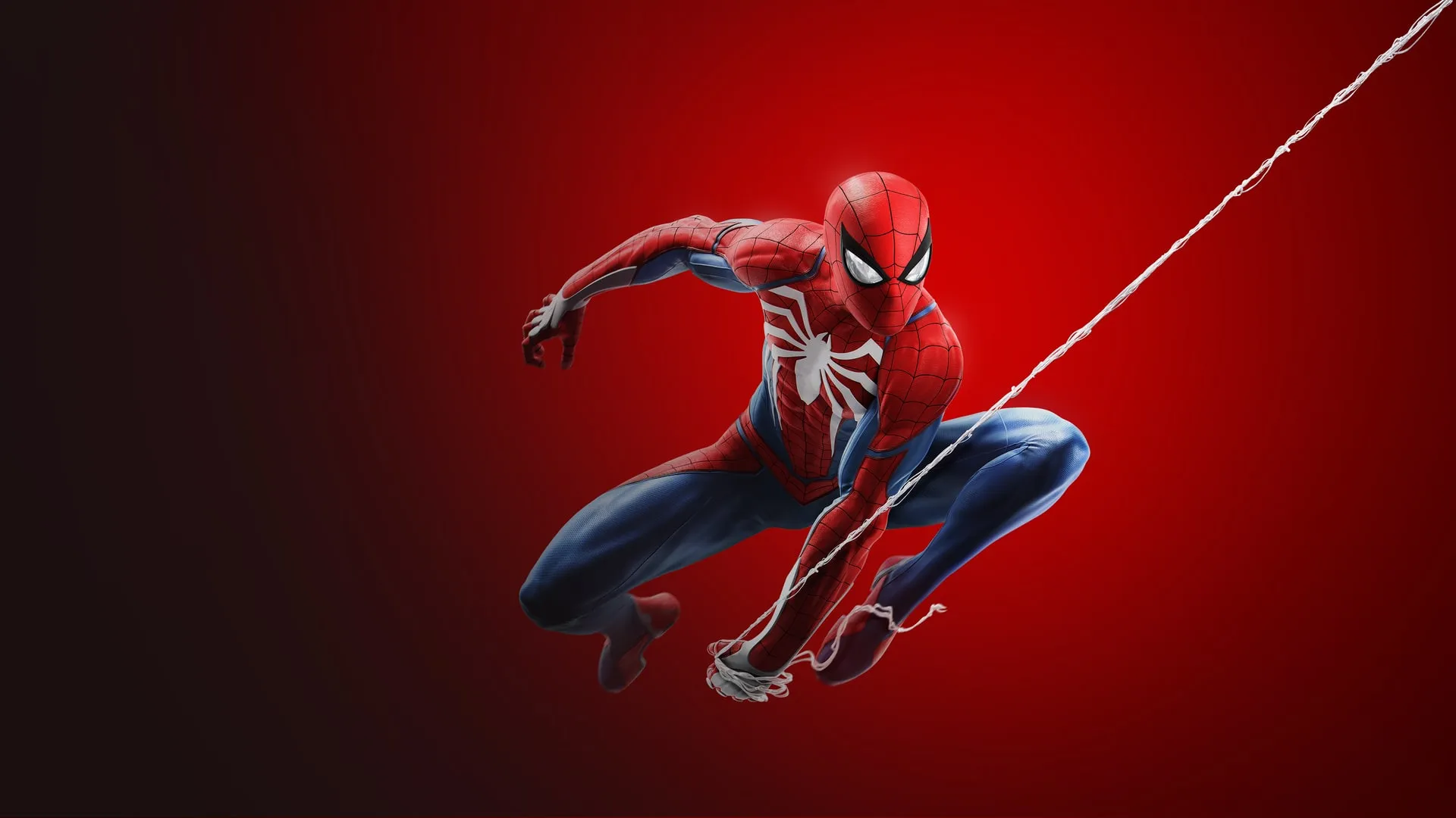Spider-Man, con su traje rojo y azul y la araña blanca en el pecho, se balancea colgado de su telaraña sobre un fondo rojo